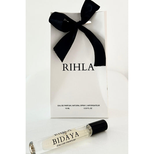 Rihla perfume packaging with a black bow and a smaller Bidaya perfume bottle in front.
