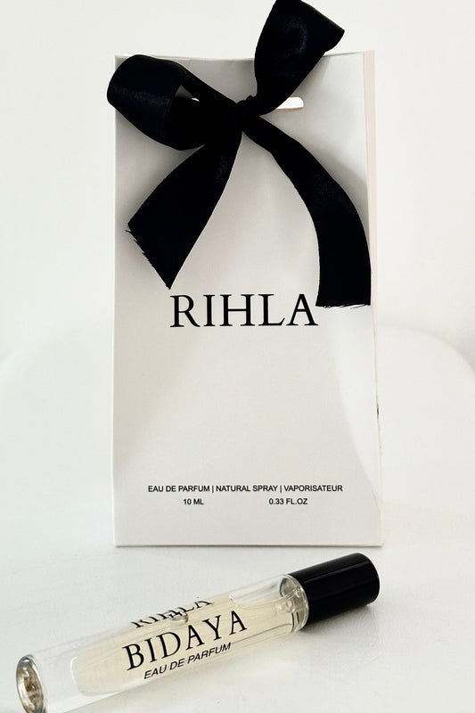 Rihla perfume packaging with a black bow and a smaller Bidaya perfume bottle in front.